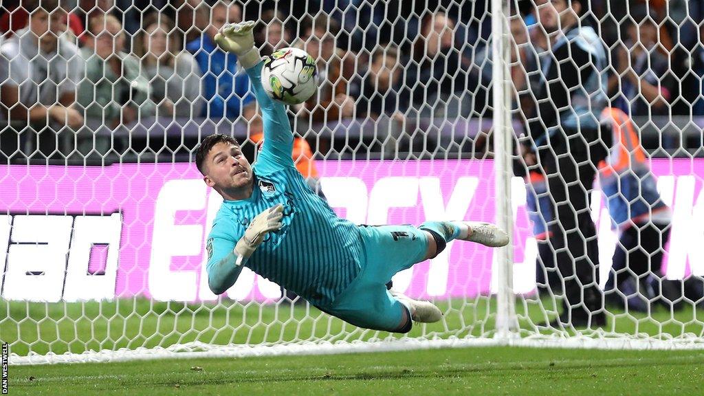 Mansfield Town goalkeeper Christy Pym makes a save in their penalty shootout win against Peterborough