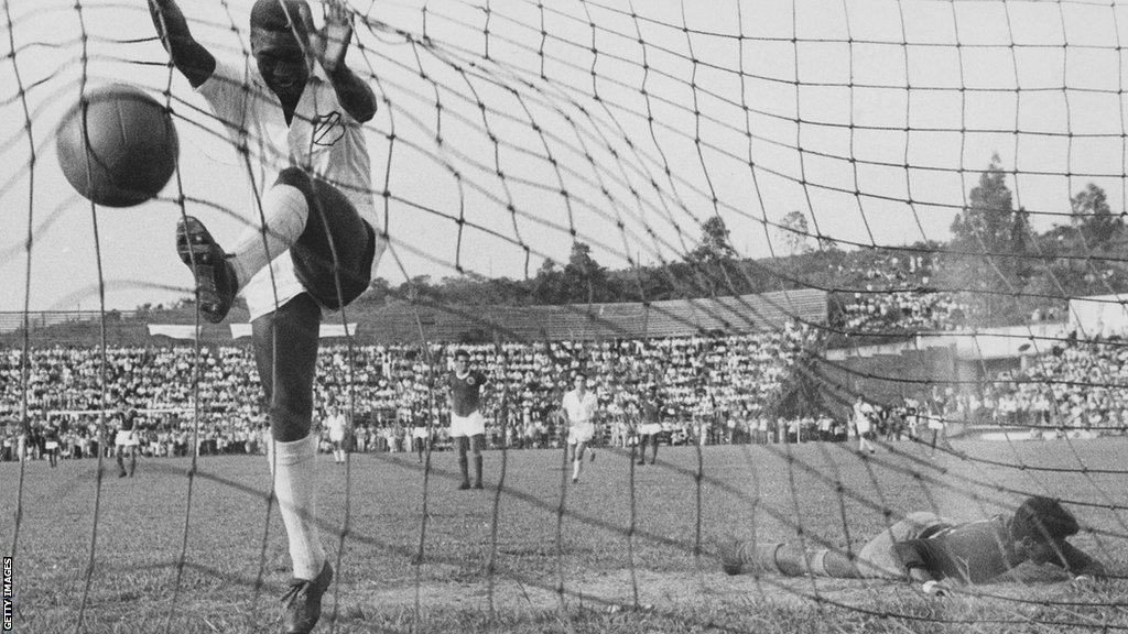 A young Pele jumps into the net after scoring for Santos against Guarani of Paraguay in 1958