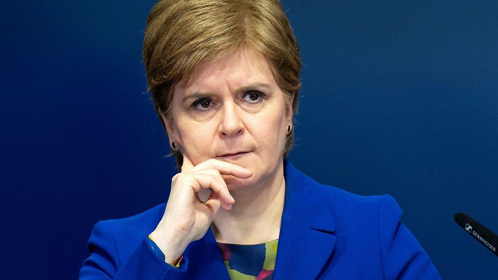 Nicola Sturgeon stands at a podium