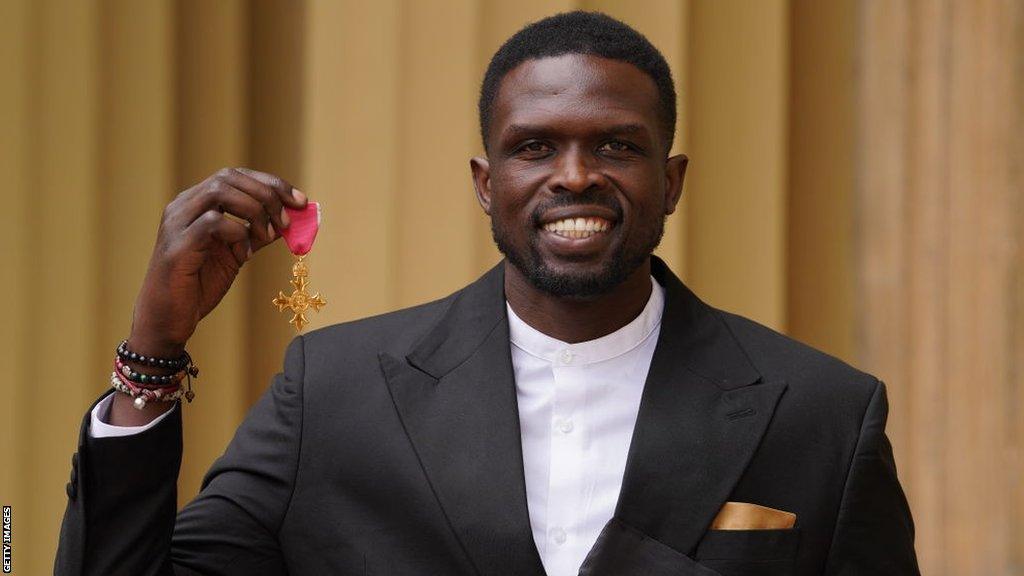 South Sudan Basketball Federation president and NBA legend Luol Deng collecting an OBE for services to basketball in 2022