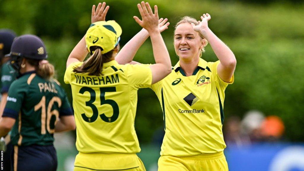 Georgia Wareham and Kim Garth celebrate taking an Ireland wicket