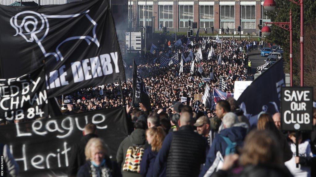 Derby County fans in their thousands on a protest march in an effort to save the club in January 2022