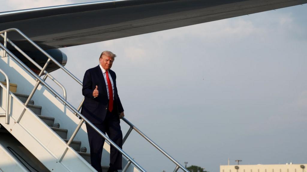 Former U.S. President Donald Trump gives a thumbs up as he arrives at Atlanta Hartsfield-Jackson International Airport on August 24, 2023 in Atlanta, Georgia.