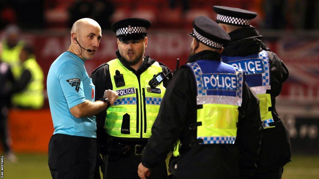 Police came onto the pitch after Crewe's late penalty winner