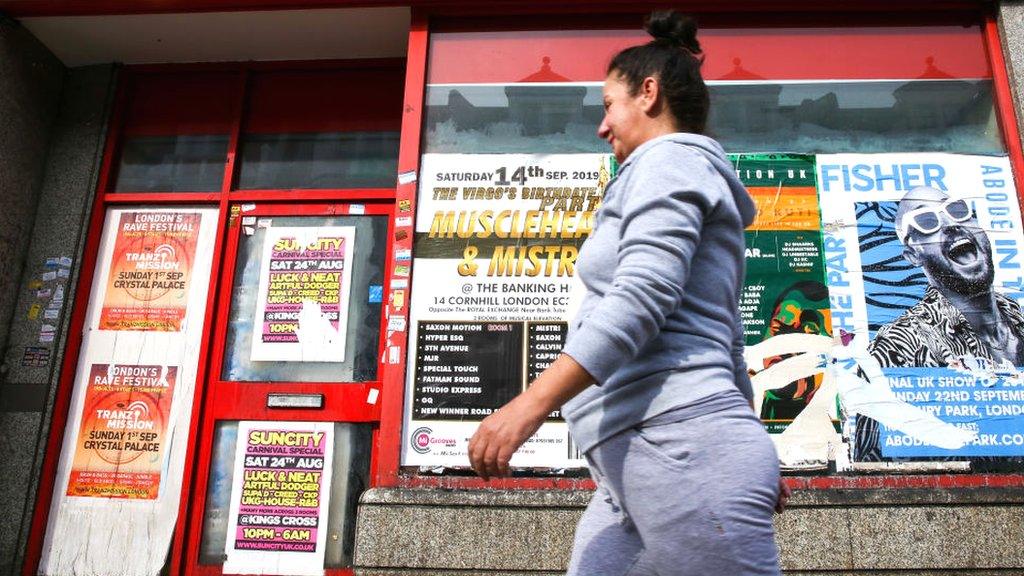 Woman walking past a closed shop