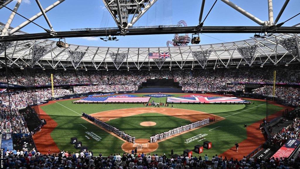 Players and fans stand for the national anthems during the MLB London Series