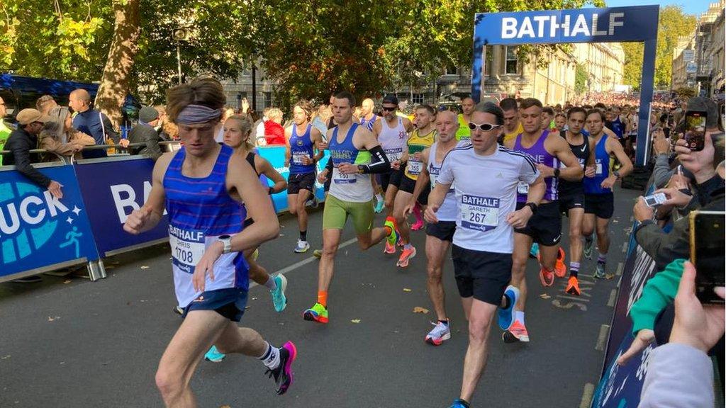 People running past start line