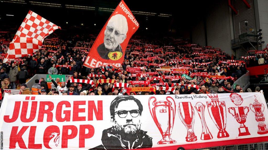 Liverpool fans hold up banners and scarves prior to the FA Cup game at home to Norwich