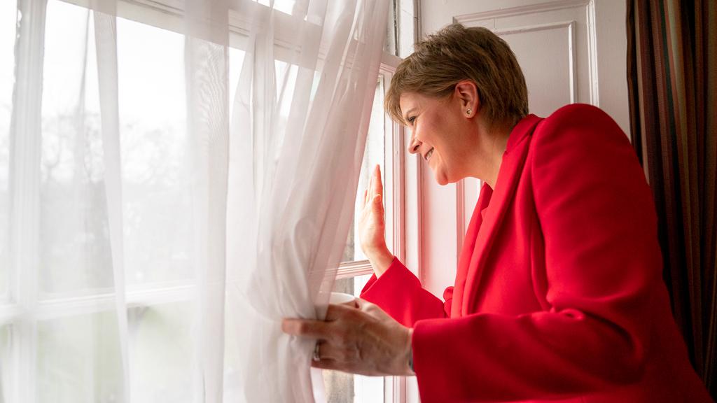 First Minister Nicola Sturgeon waves from a window of Bute House in Edinburgh after announcing she was standing down as first minister of Scotland after eight years - 15 February 2023