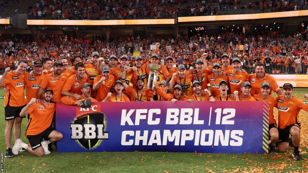 Perth Scorchers celebrating with the Big Bash trophy