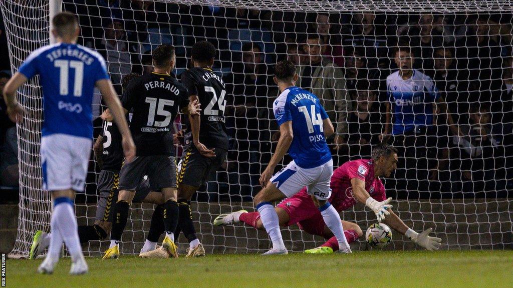 Robbie McKenzie scores his first of two goals for Gillingham against Southampton