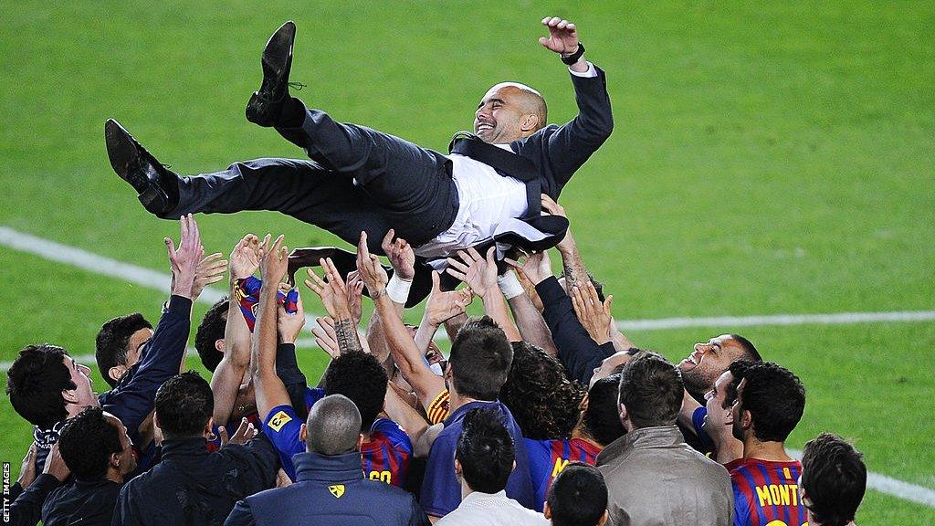 Pep Guardiola is hoisted into the air by Barcelona players and staff