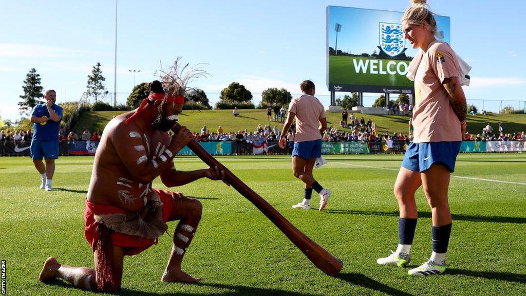 England's Millie Bright looks on as a smoking ceremony is conducted by the Gubbi Gubbi People following a training session at the Sunshine Coast Stadium