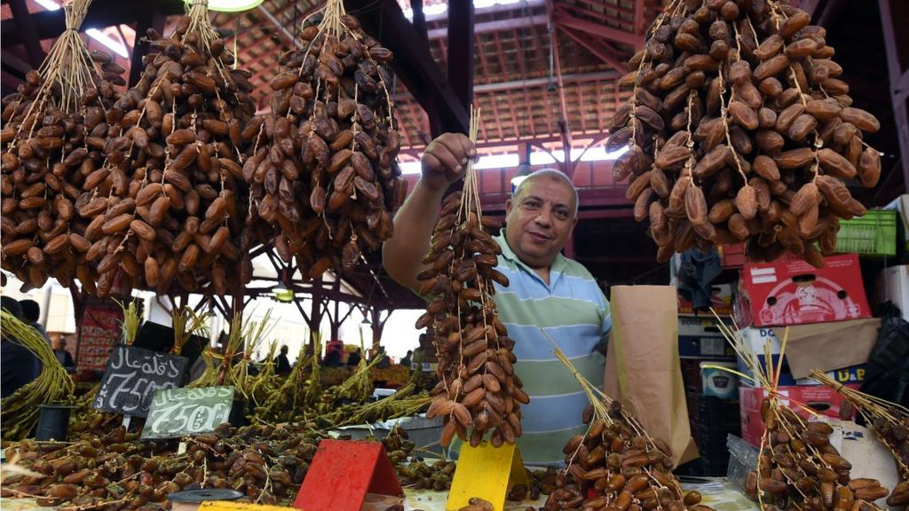 A man holds up his wares in Tunis, Tunisia