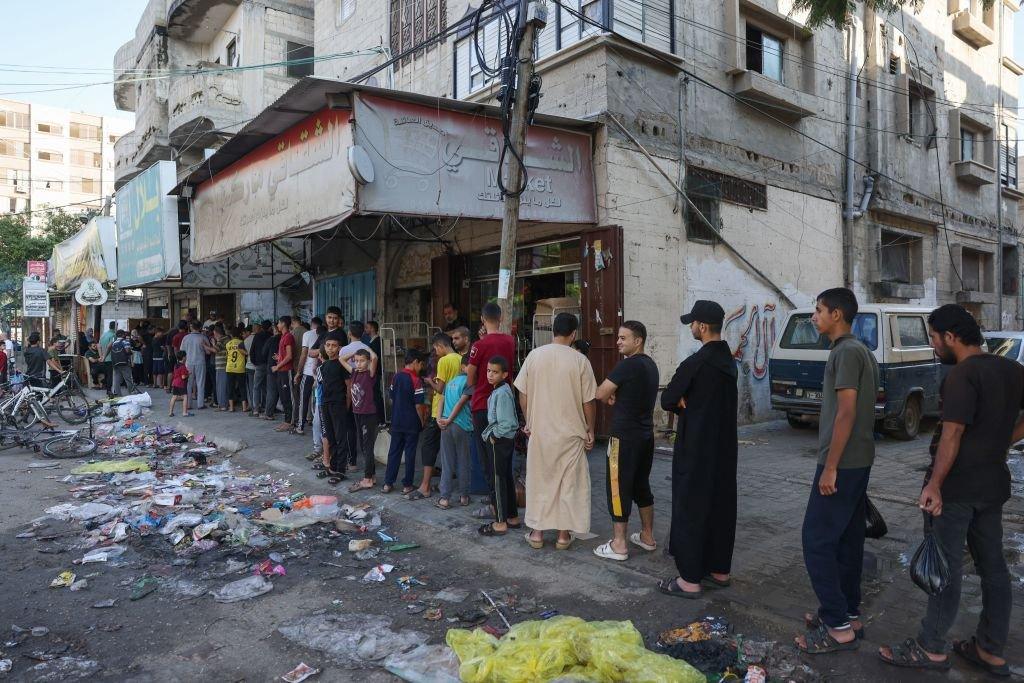 A long queue of Palestinians outside a bakery in Rafah