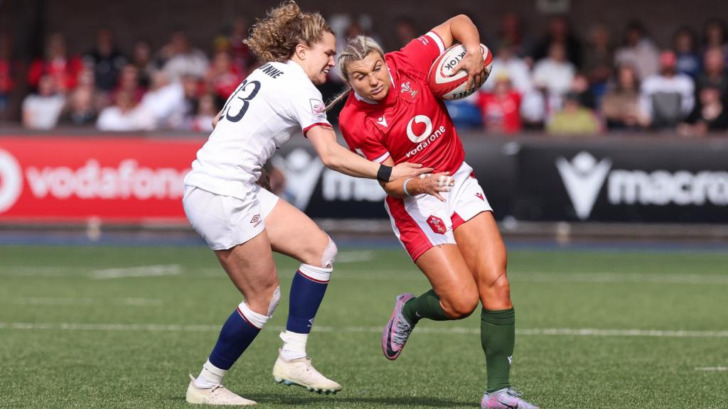 Lowri Norkett of Wales is tackled by Ellie Kildunne of England in the Women's Six Nations