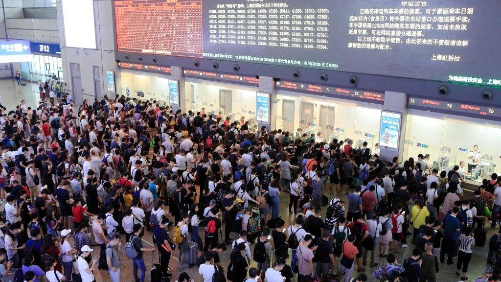 queues-train-station-typhoon-china.