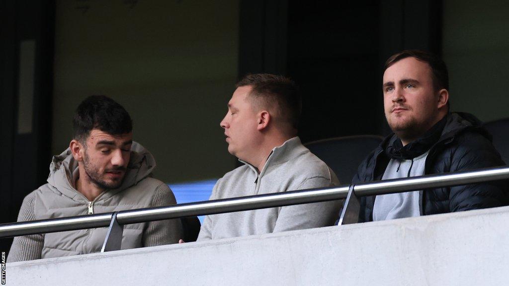 Luke Littler sitting in a hospitality box watching Tottenham v Bournemouth