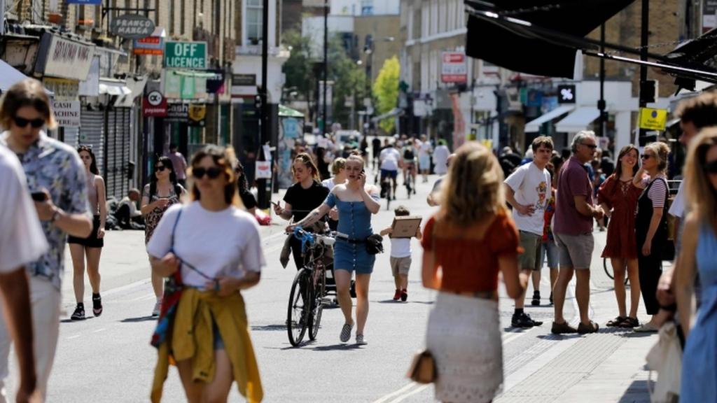 People get out in the sunshine in Broadway Market, Hackney, London on 20 May, 2020