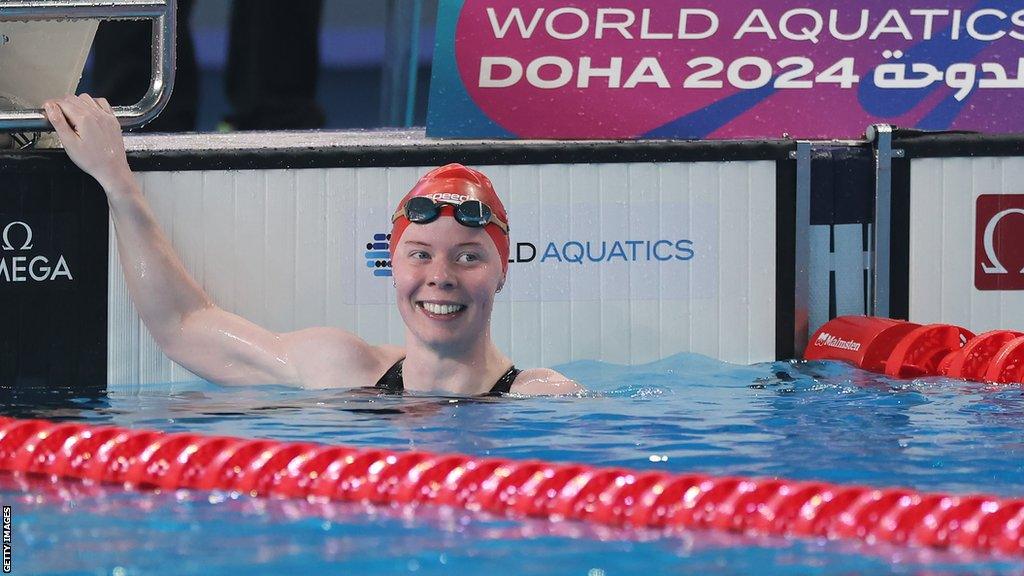 Laura Stephens smiles after finishing first in 200m butterfly