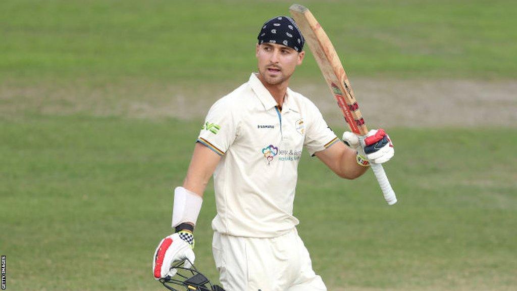 Leus du Plooy raises his bat after reaching his century