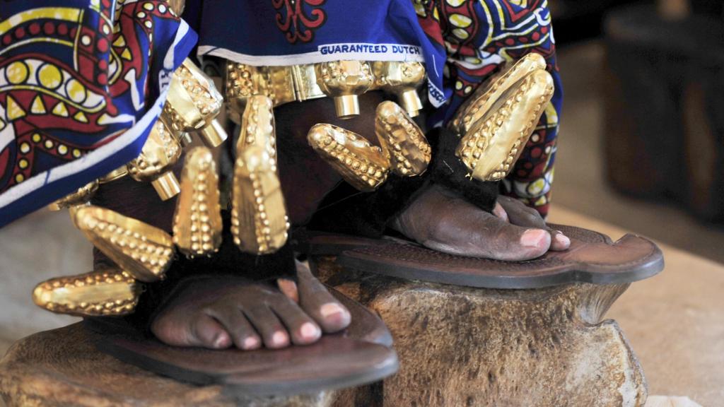 A closeup shows the shoes of the king of the N'Zima Kotoko people and first vice president of the Ivorian Commission on Dialog, Truth and Reconciliation, Awoulae Desire Amon Tanoe, as he sits on his throne