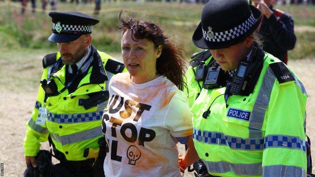 A protester is escorted away by police