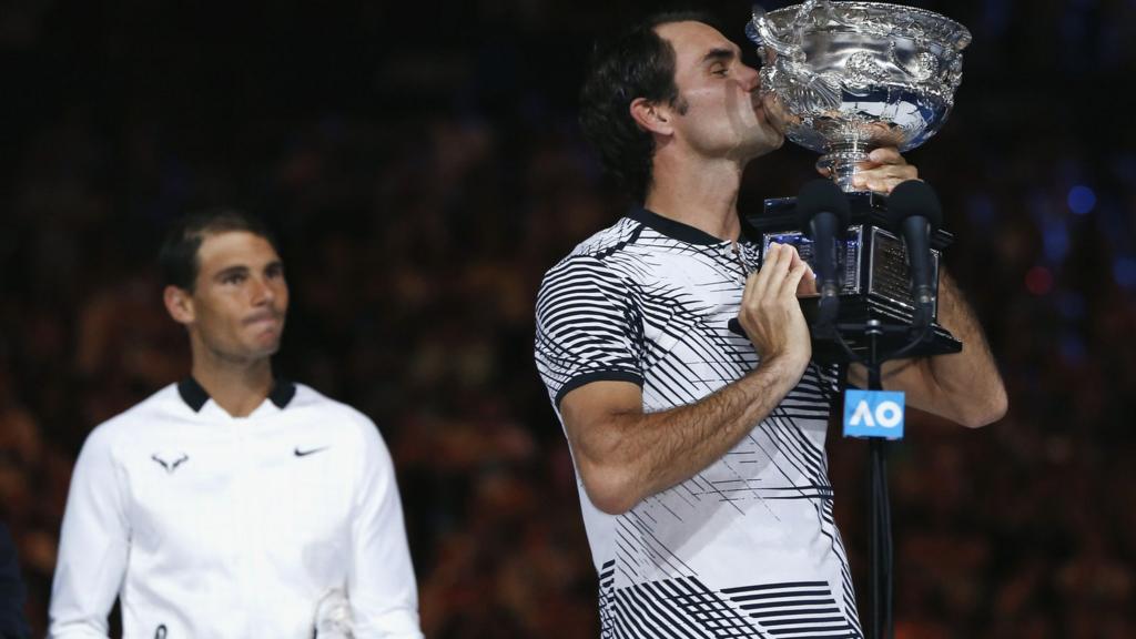 Roger Federer kisses the trophy