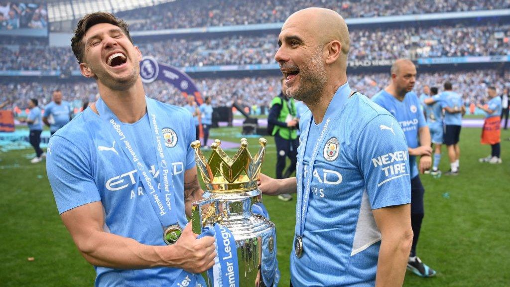 Pep Guardiola and John Stones celebrate