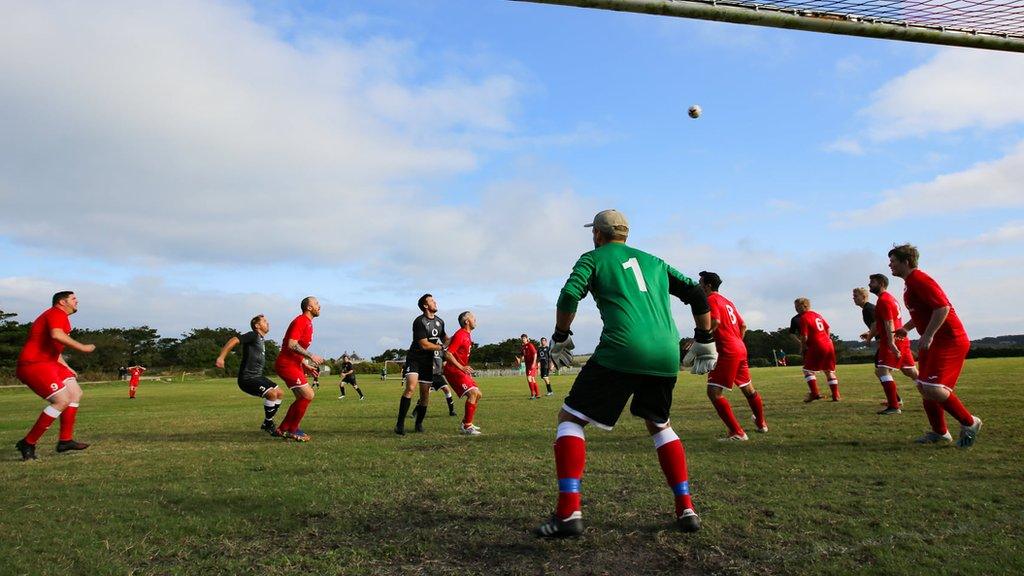 The Garrison Gunners and Woolpack Wanderers contest an aerial ball