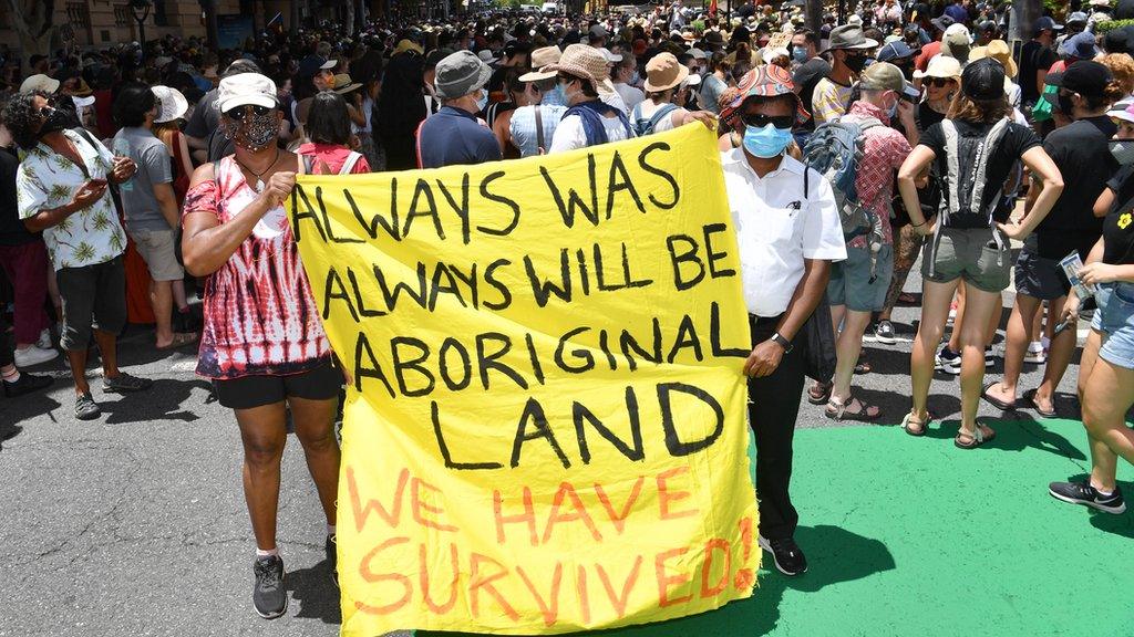 Protestors are seen during an Invasion Day rally in Brisbane