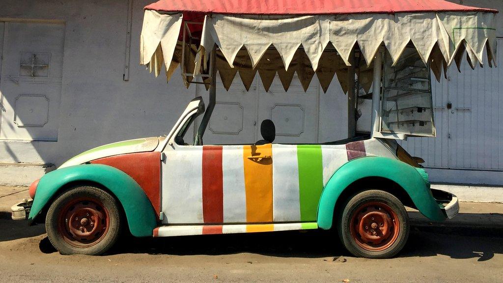 Stripey Volkswagen Beetle underneath a canopy shade