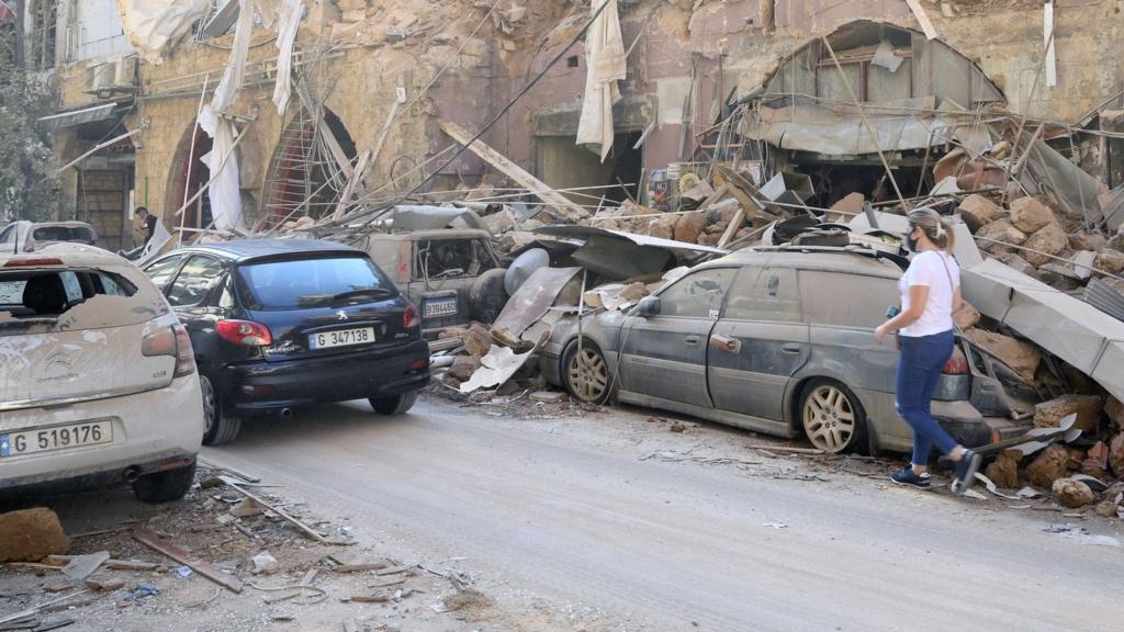 Vehicles damaged in the aftermath of a huge blast in Beirut