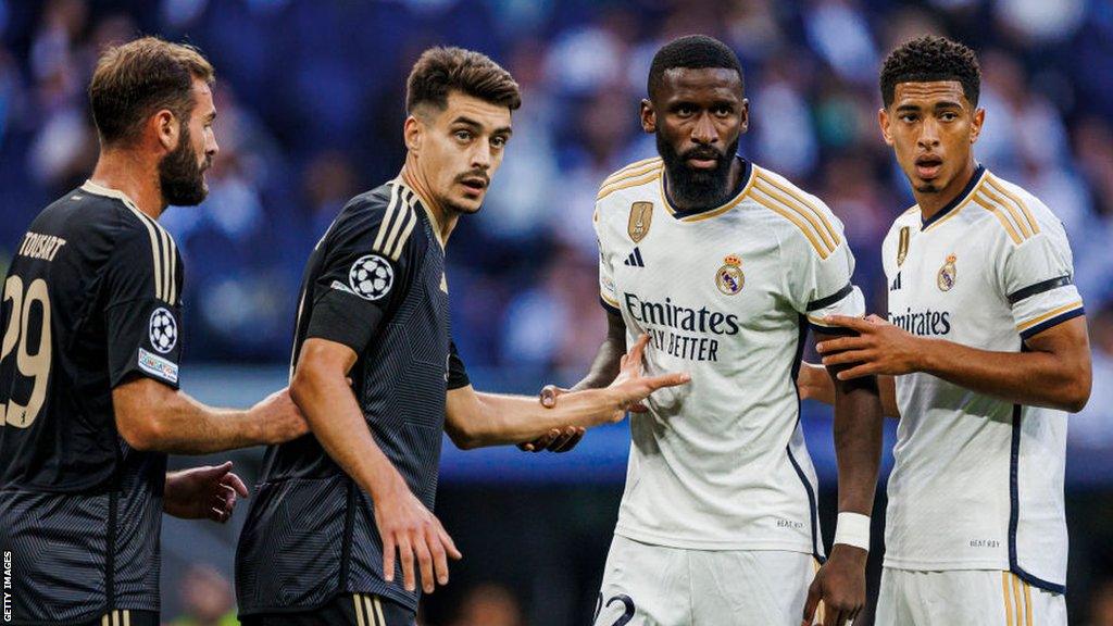 Real Madrid and Union Berlin players tussle for the balll