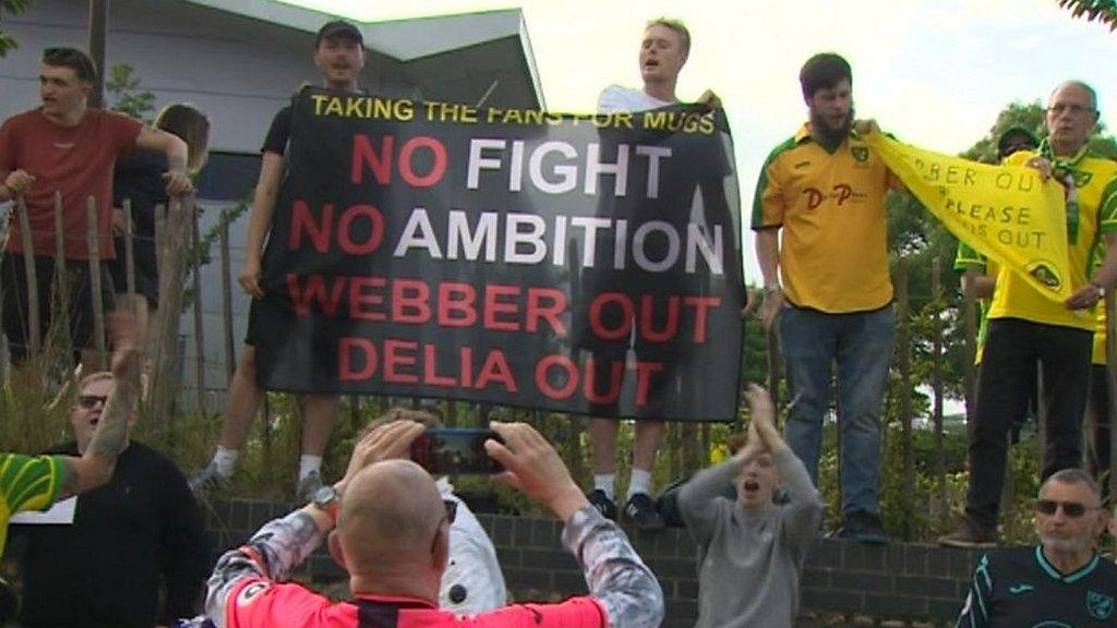 Norwich City fans at Carrow Road with Delia out banner