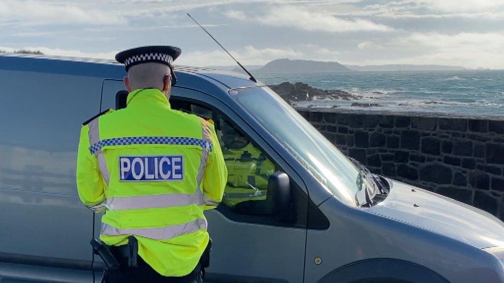 Police officer speaking to a driver