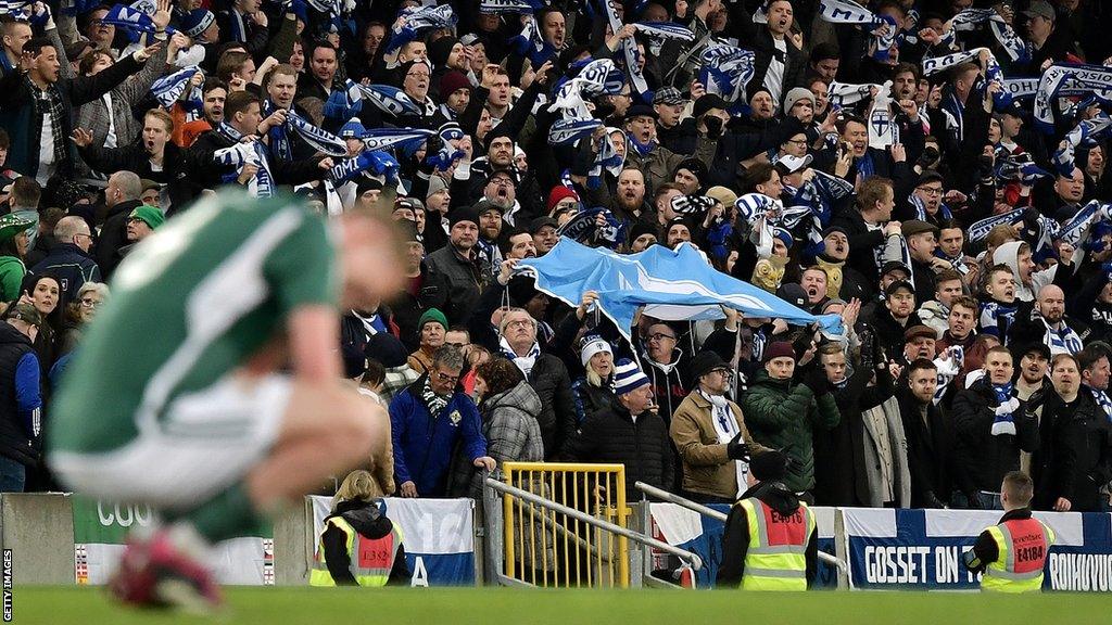 George Saville dejected at full-time as Finland supporters celebrate