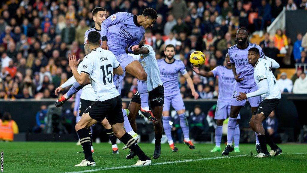 Jude Bellingham heads the ball towards goal