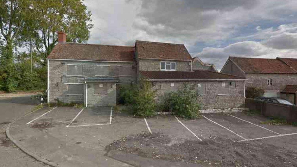 A grey, derelict former pub