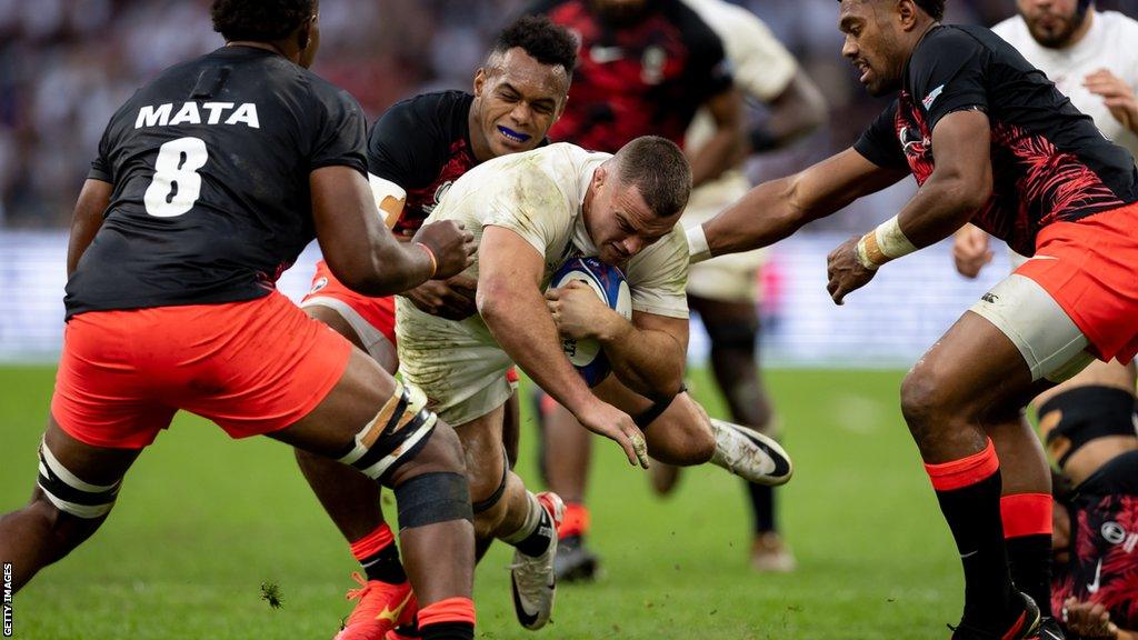 Ben Earl being tackled by Fiji players