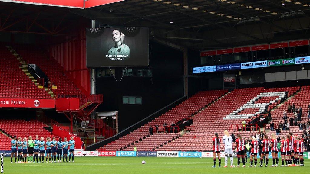 Players, officials and fans take part in a minute's applause in memory of Maddy Cusack