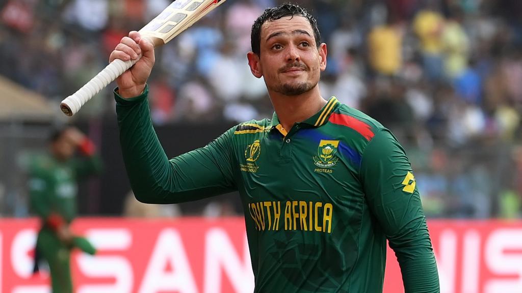 South Africa batter Quinton de Kock raises his bat as he walks off after making 174