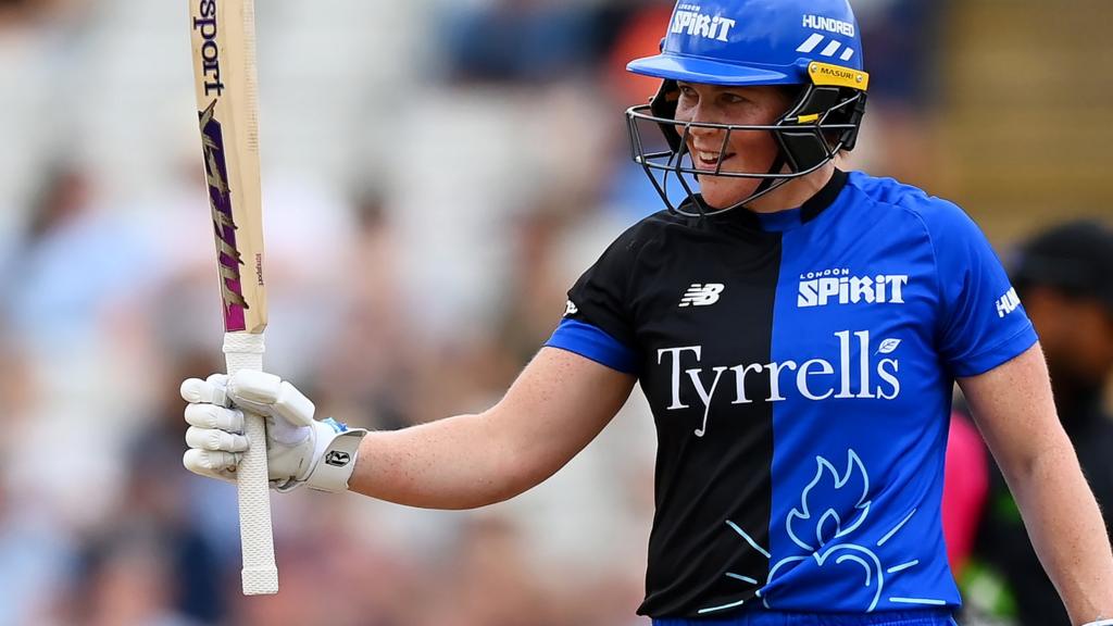 London Spirit batter Grace Harris raises her bat after reaching fifty