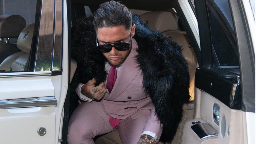 Stephen Bear dressed in a pink suit and tie with black fur coat outside Chelmsford Crown Court