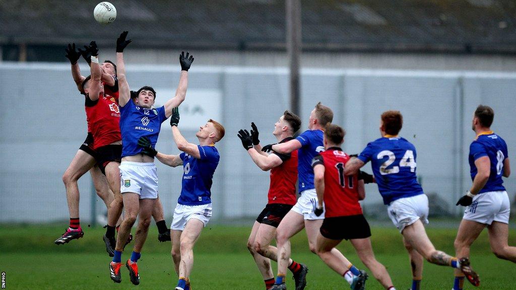 Down's Johnny Flynn and Daniel Guinness of Down fight out at aerial duel with Wicklow's Cathal Baker at Aughrim