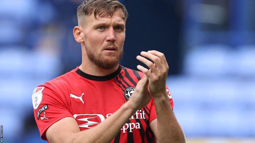 Charlie Wyke applauds the Wigan fans