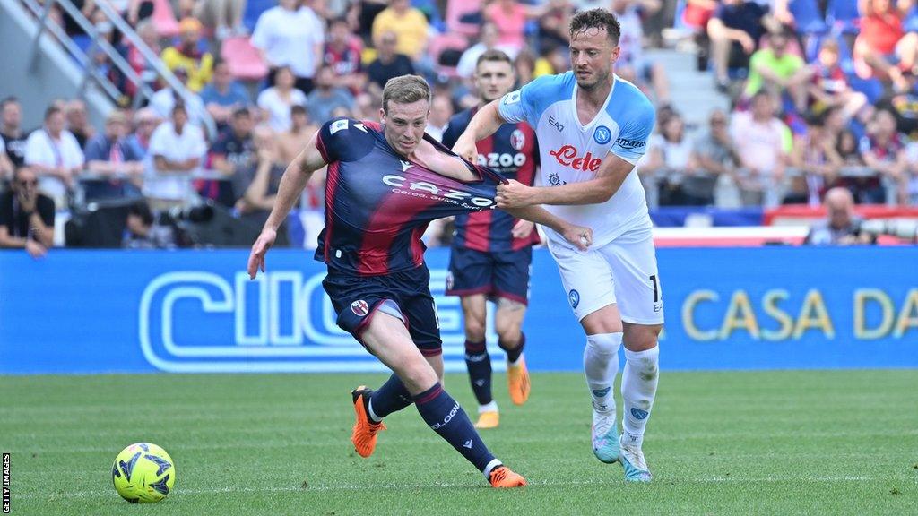 Bologna midfielder Lewis Ferguson (left) in action against Napoli