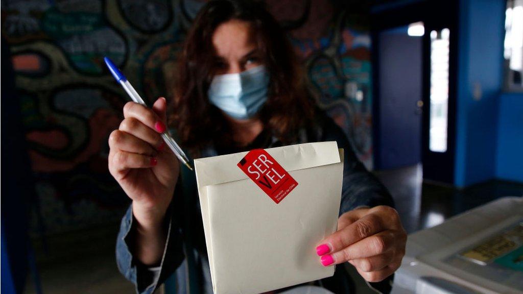 A Chilean woman shows her votes during the Constitutional Convention Election