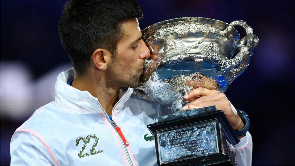 Novak Djokovic kisses the Australian Open trophy