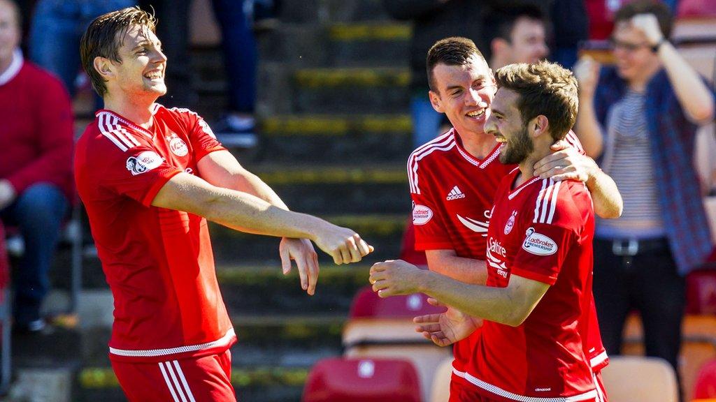 Graeme Shinnie (right) celebrates his opener with Ash Taylor (left) and Paul Quinn.